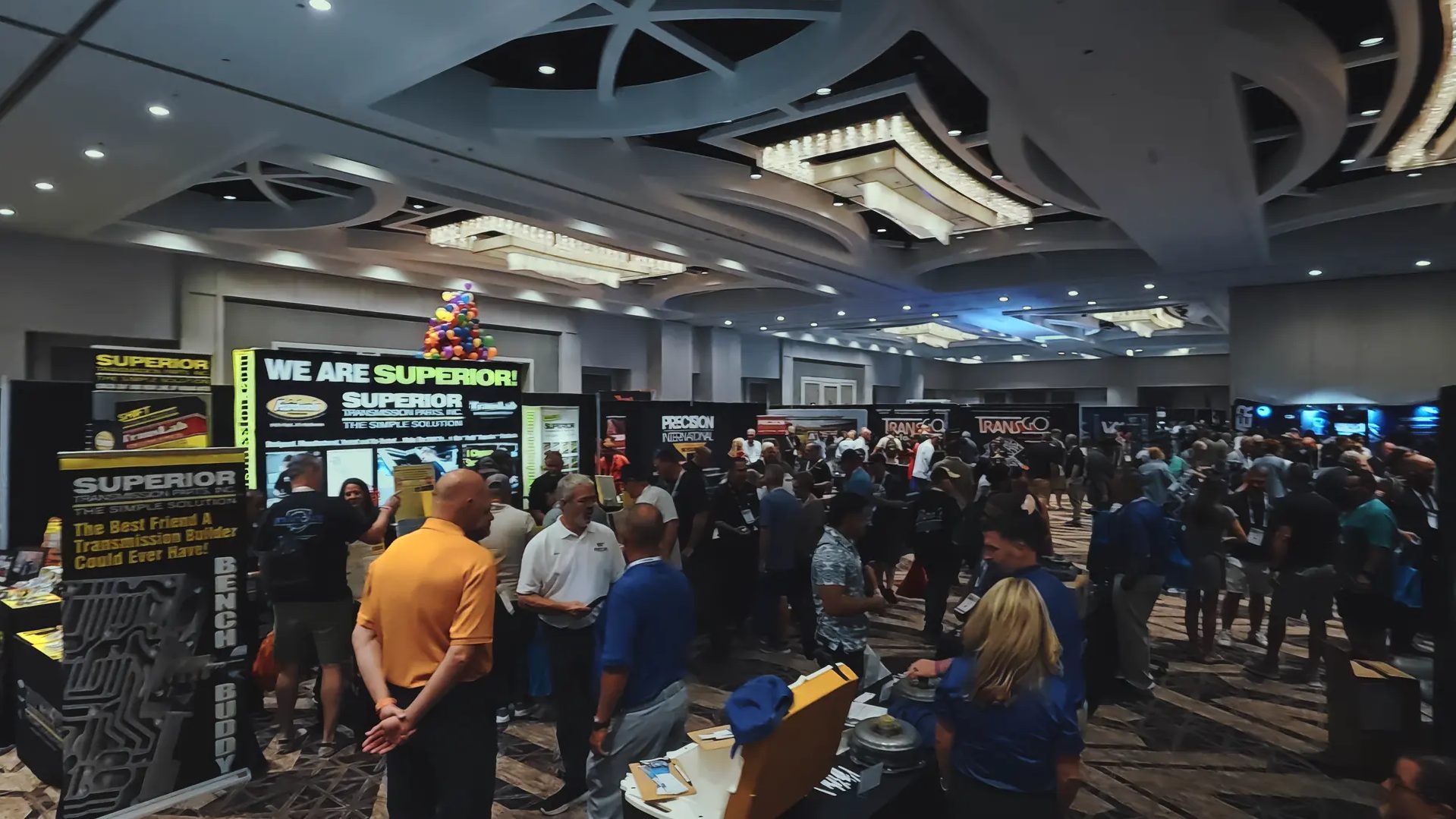 Attendees visiting exhibitor booths on a previous Powertrain Expo trade show floor